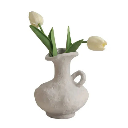 DecorBites™ nordic style ceramic flower pot in white with a handle holds two pale yellow tulips