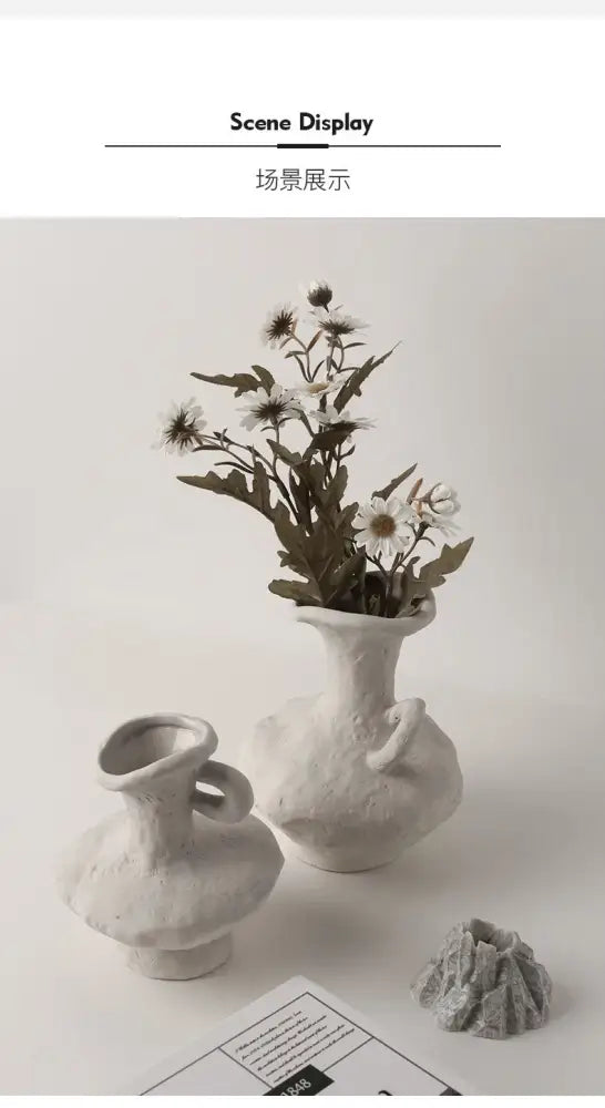 Decorbites nordic style ceramic flower pot in white with textured rounded body holding delicate white daisies