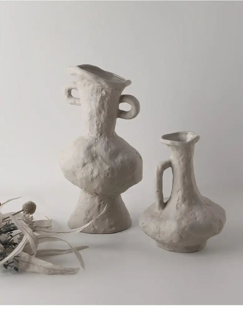 Two textured matte gray ceramic vases with organic looped handles in a nordic style ceramic flower pot white design