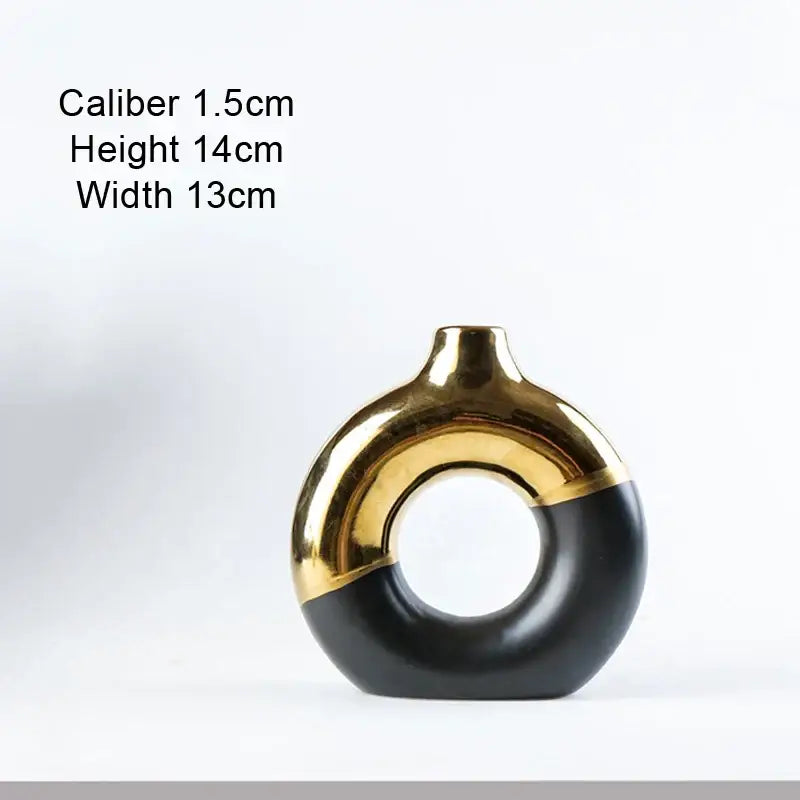 A sleek black and gold ceramic nordic style circle vase with modern ring-shaped design for flower arrangement