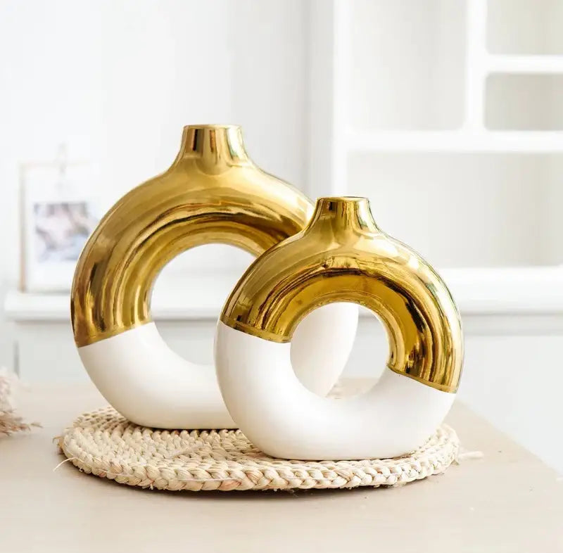 Two modern ceramic nordic style circle vases with glossy gold upper half and matte white lower half for flower arrangement