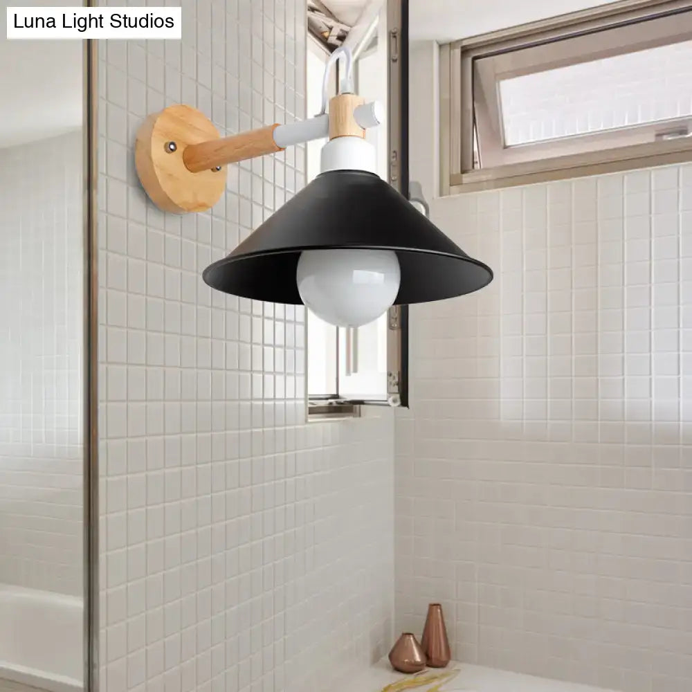 Nordic black and wood conic wall sconce with wooden arm and white bulb mounted on tiled wall for bedroom lighting