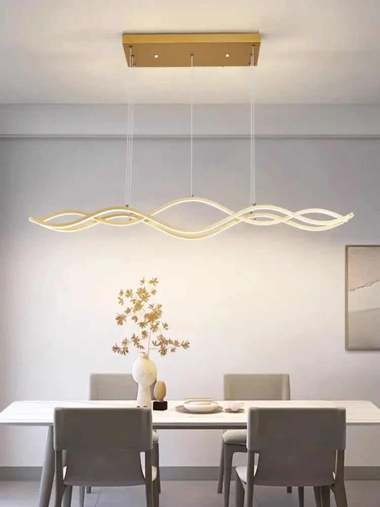 Gold-toned modern led pendant light with wavy arms for nordic style dining room chandeliers by decorbites