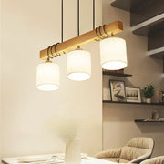 DecorBites™ nordic style led hanging light with three cylindrical white fabric shades and wooden accents for dining spaces