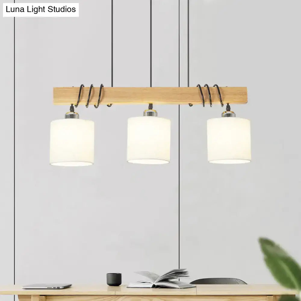 Modern three-light led hanging light by decorbites with wood beam black coiled wire and white fabric shades for dining