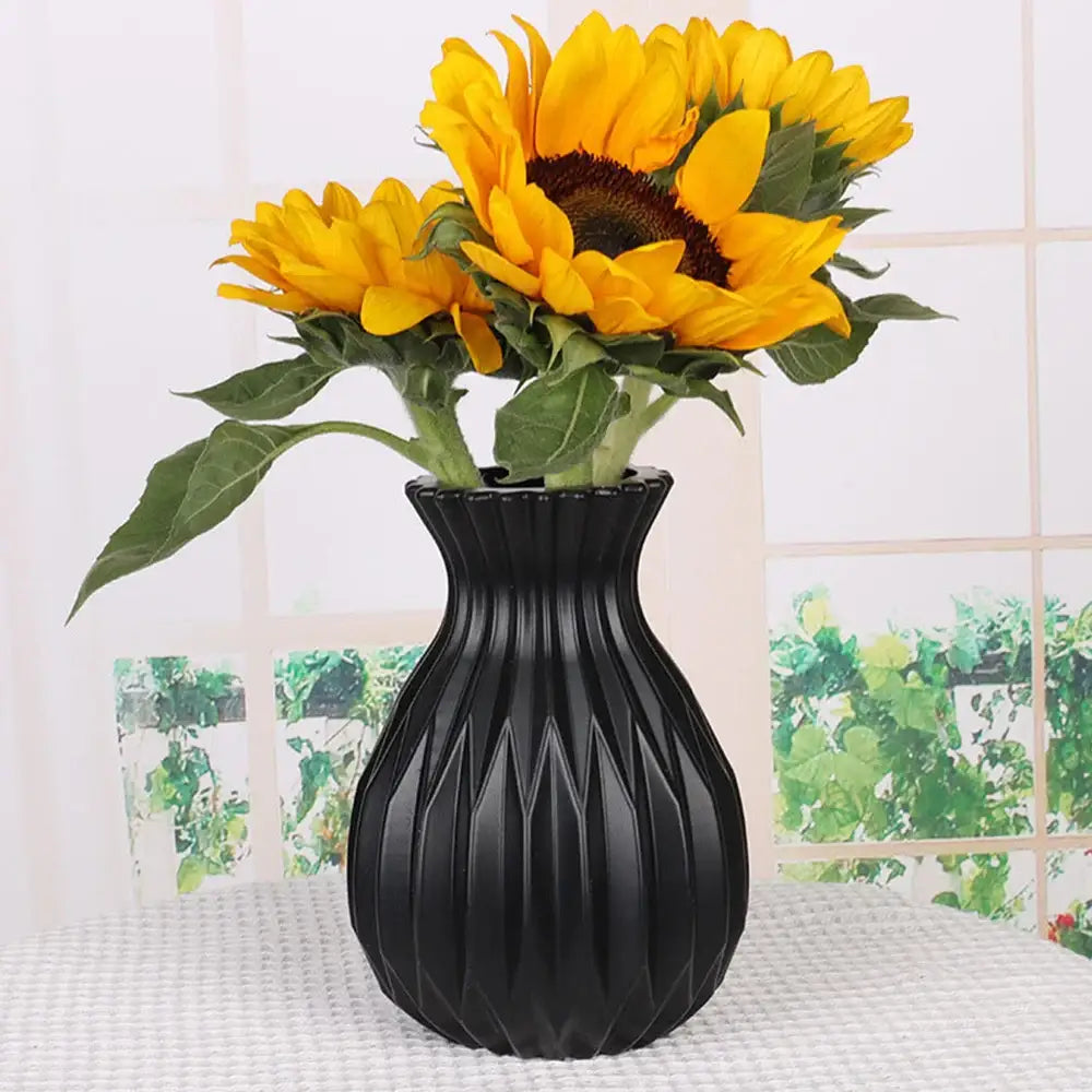Black ribbed ceramic flower vase holding yellow sunflowers for home decor by DecorBites™ Nordic style plastic flower vase