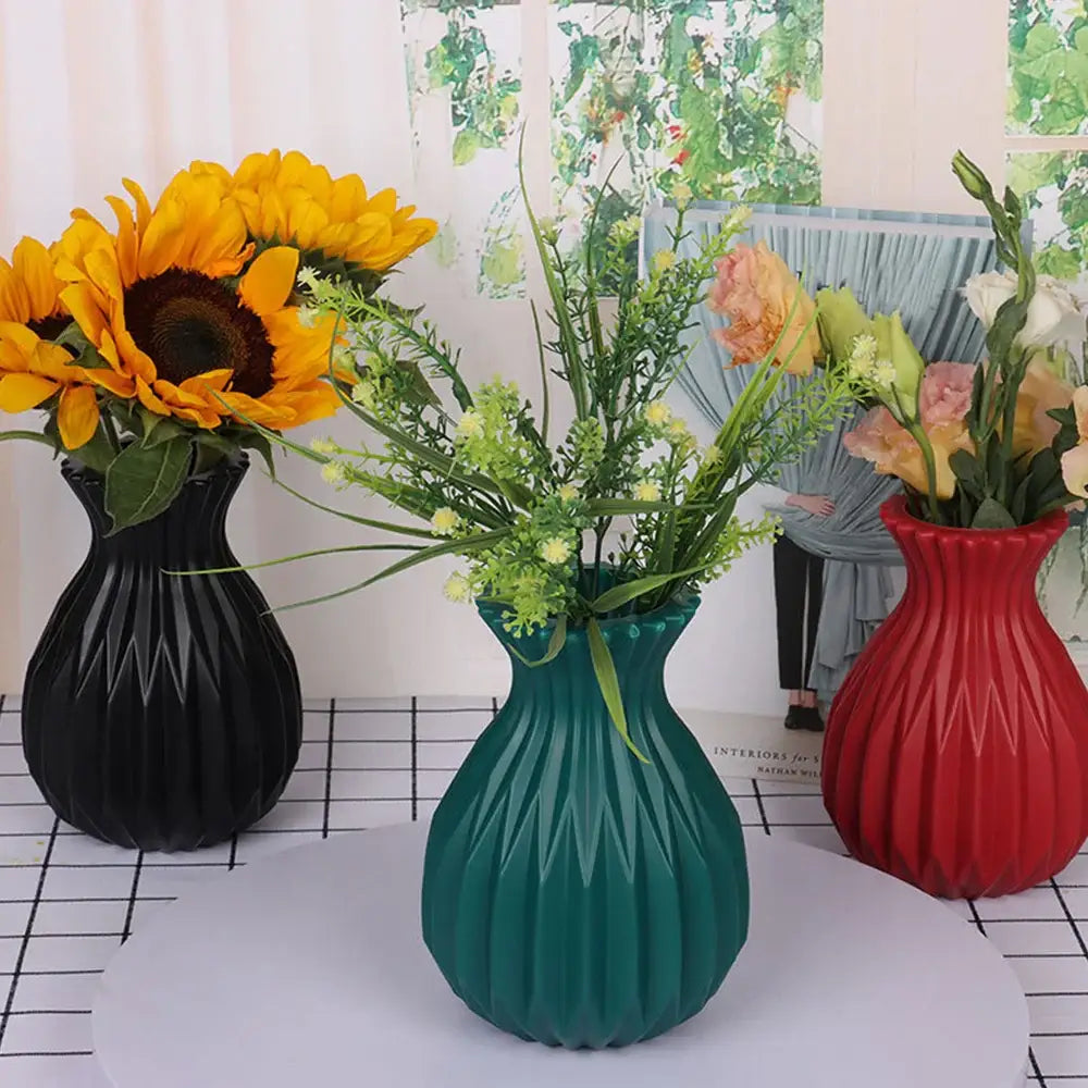 Three glossy black teal and red ribbed plastic flower vases from decorbites for stylish home decor arrangements