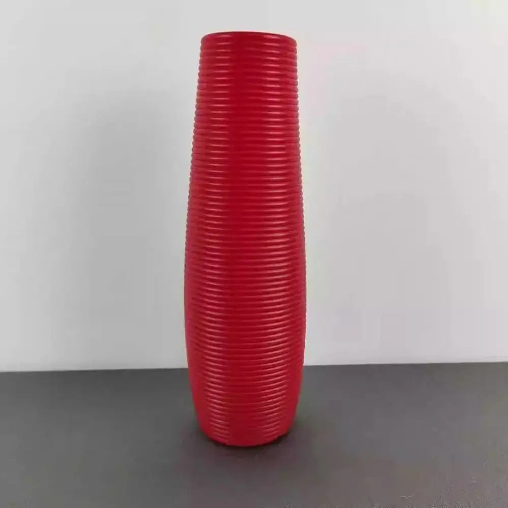 A tall vibrant red decorbites nordic style plastic flower vase with a textured ribbed surface for home decor