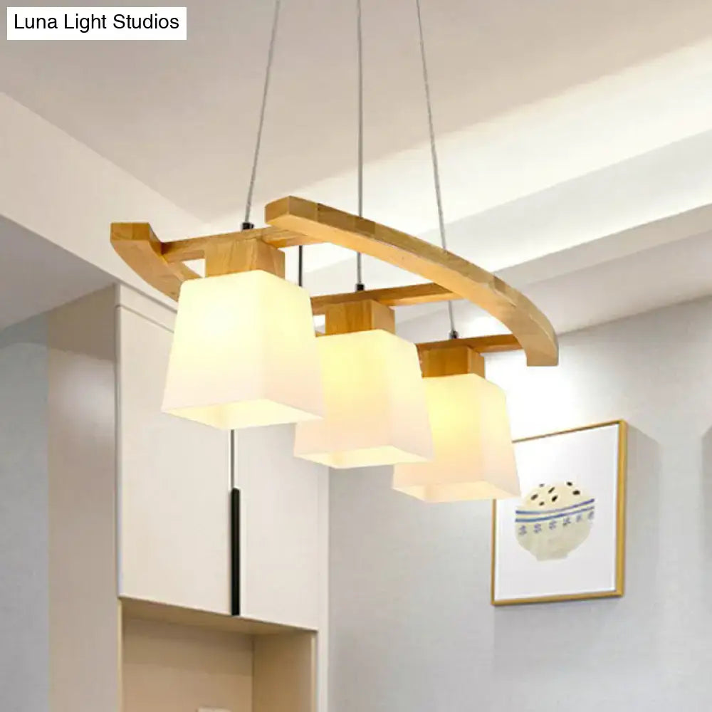 Modern wooden pendant ceiling light with three warm white glass shade squares for dining room by decorbites