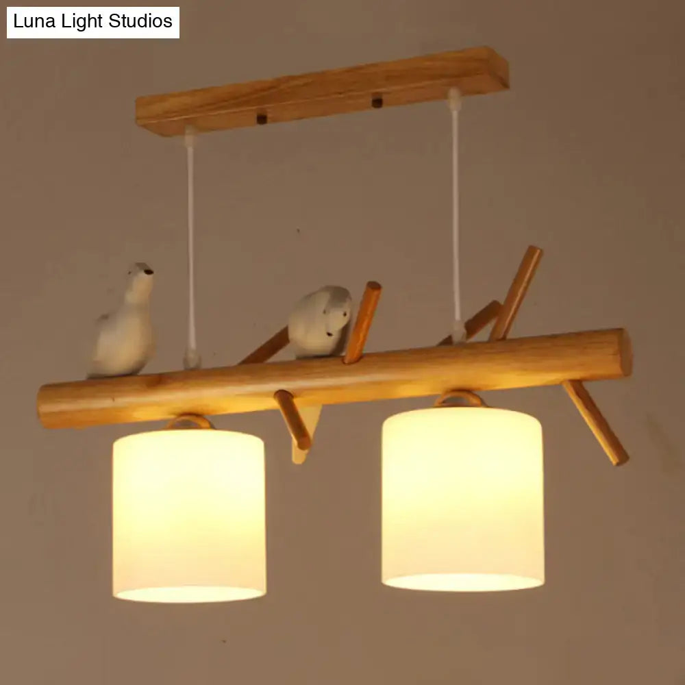 Decorbites™ nordic wood pendant light features warm opal glass cylinder lampshades with resin bird decor accents