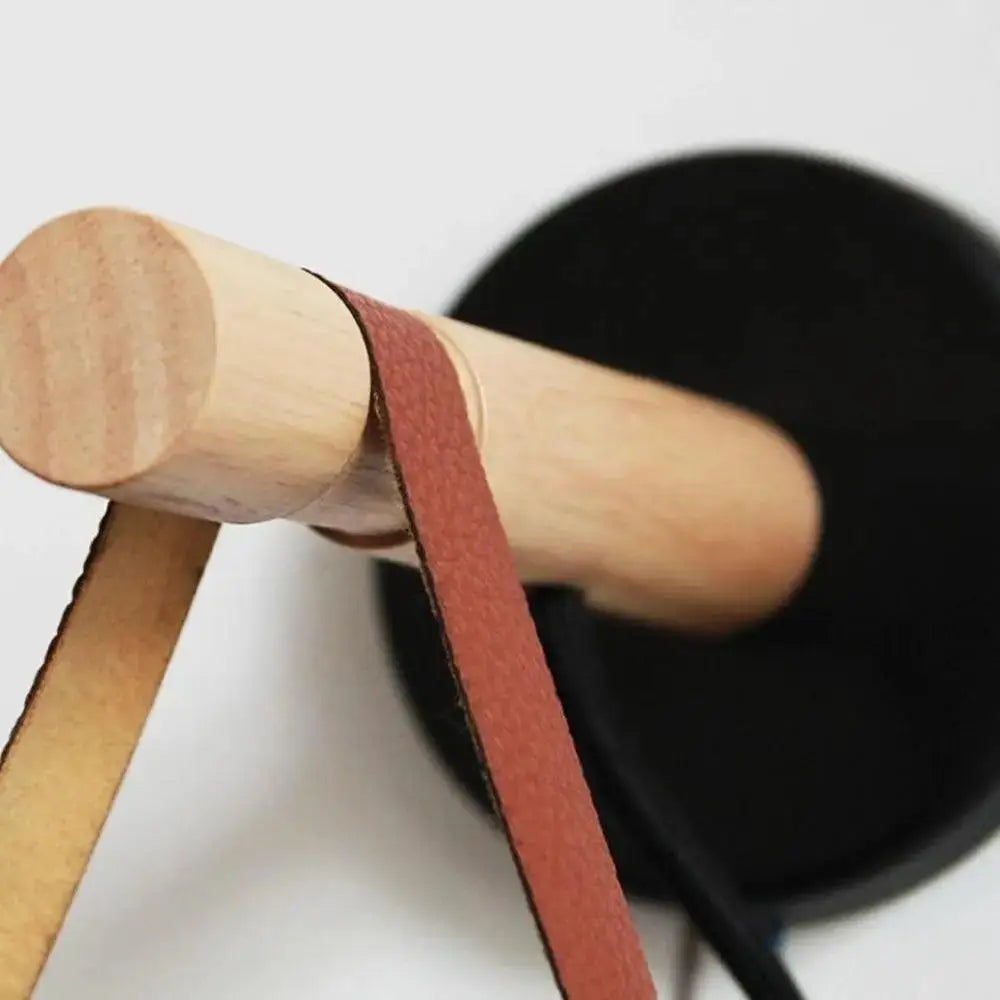 A rustic wooden handle with a reddish brown leather strap on decorbites™ nordic wooden wall lights for stylish wall lights