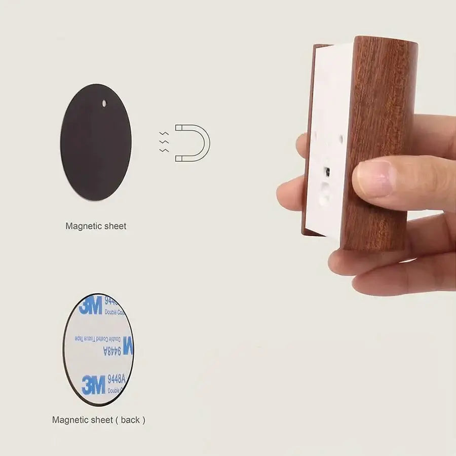 Wooden-handled magnetic wall mount with white backing and adhesive tape for secure attachment of battery operated wall sconce