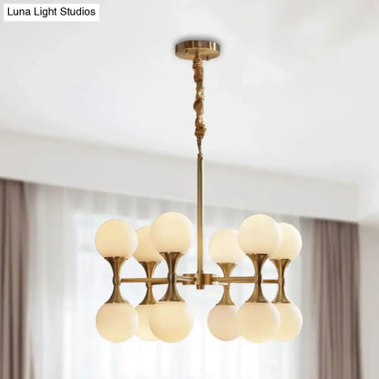 Brass-finished decorbites opal glass chandelier light with eight frosted glass globe shades in two tiers