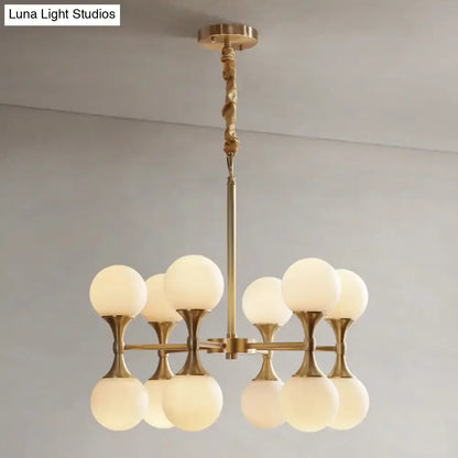 Brass-finished opal glass chandelier with eight frosted glass globe shades in two tiers for ceiling lighting