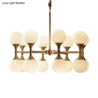 Decorbites opal glass chandelier light with 12 brass globe heads and frosted opal glass shades in brass finish