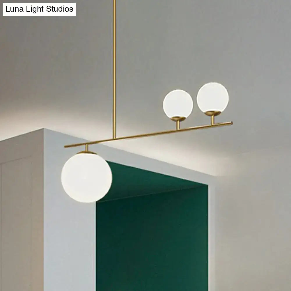 Modern brass pendant hanging lamp with three frosted opal glass globe shades for elegant island lighting