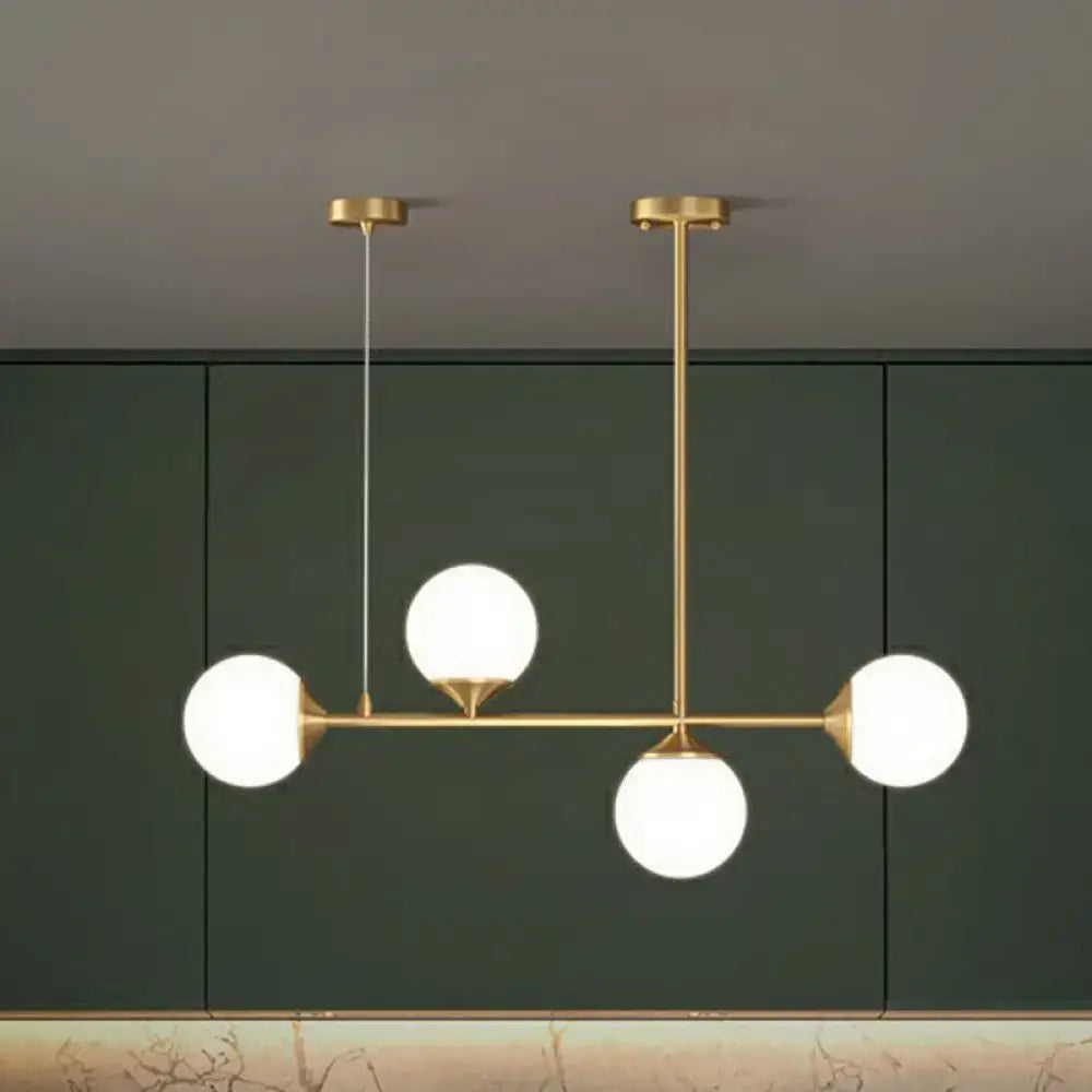 DecorBites™ opaline glass ball pendant light with brass finish and frosted globes for minimalist dining room island
