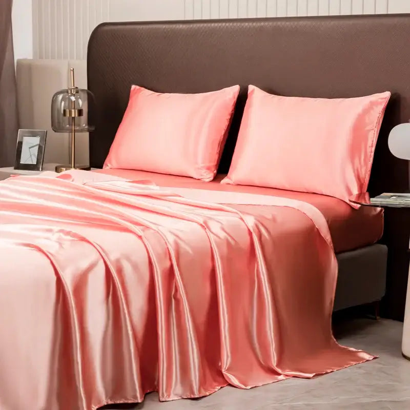 Pink satin bedding set by decorbites featuring matching pillowcases and fitted sheet for luxurious bedroom decor