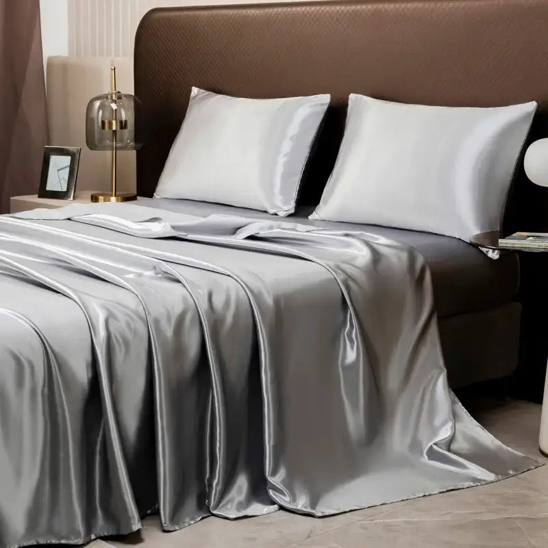 Silver satin bedding set by DecorBites™ featuring a smooth glossy finish with matching flat sheet and pillowcases