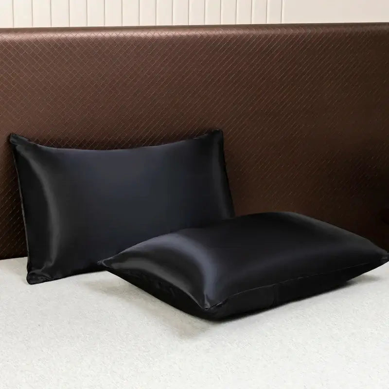 Two black satin pillowcases with a smooth glossy finish from decorbites™ opulent solid color satin bedding set