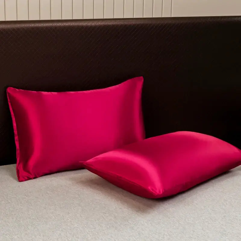 Vibrant fuchsia satin pillowcases with a smooth glossy finish from the decorbites opulent solid color satin bedding set