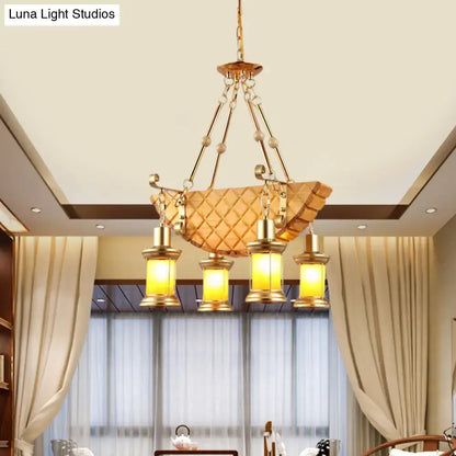Gold-toned DecorBites™ pendant light with orange glass quilted shade and fish guitar design lantern fixtures