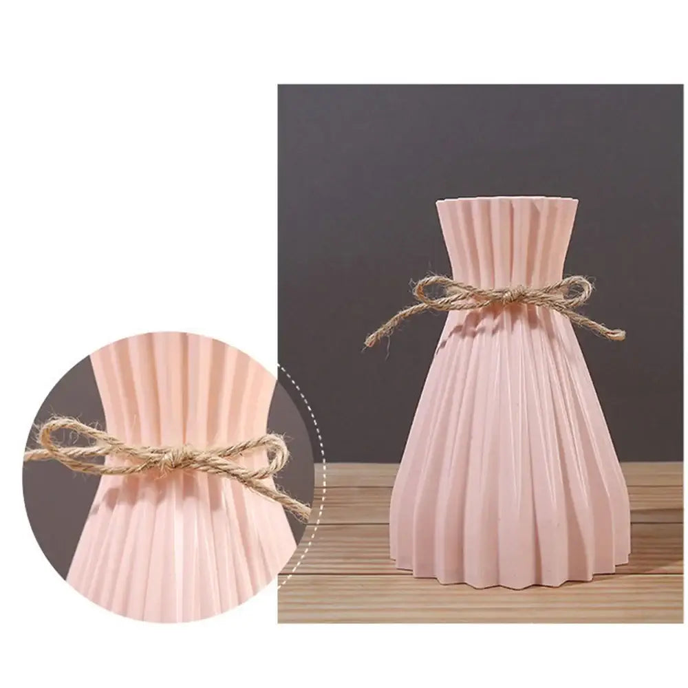 A blush pink pleated ceramic origami vase with rustic twine bow decorative for plastic flower vase display