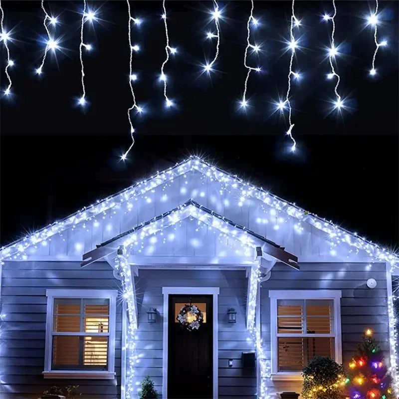 White led outdoor christmas waterfall curtain string lights draped along the roofline and front porch of a house