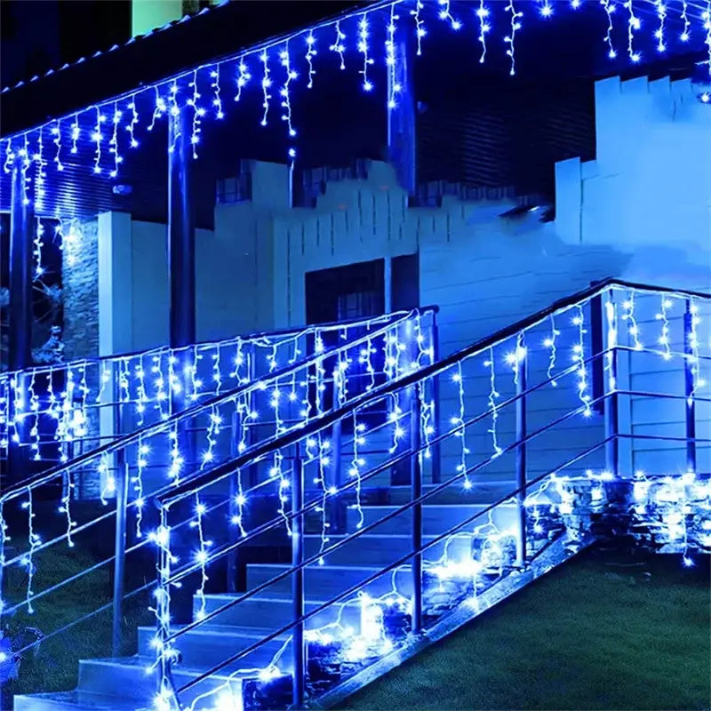 Decorbites™ outdoor christmas waterfall blue icicle curtain string lights hanging along porch staircase railing