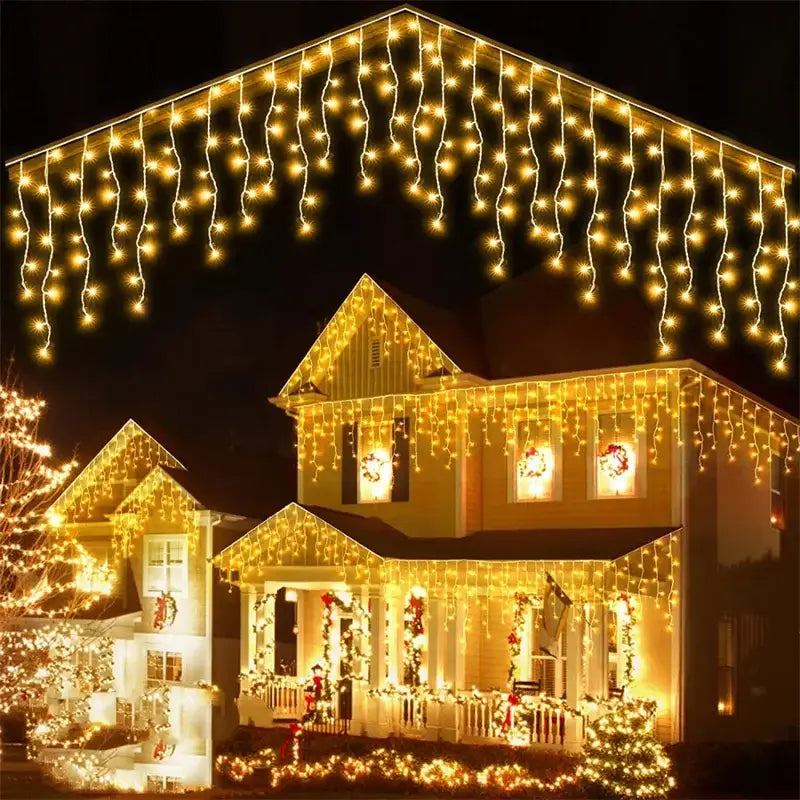 Warm golden decorbites™ outdoor christmas waterfall curtain string lights create a festive holiday display on a house