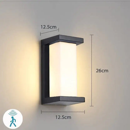 Black rectangular DecorBites™ led porch light with frosted glass panel emitting warm white illumination for outdoor use