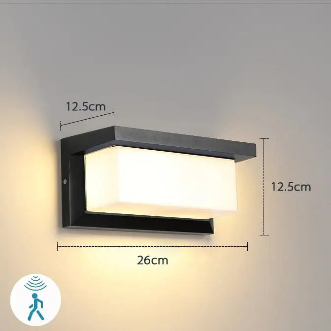 DecorBites™ outdoor motion activated led porch light with black rectangular design and frosted glass panel emitting warm white light