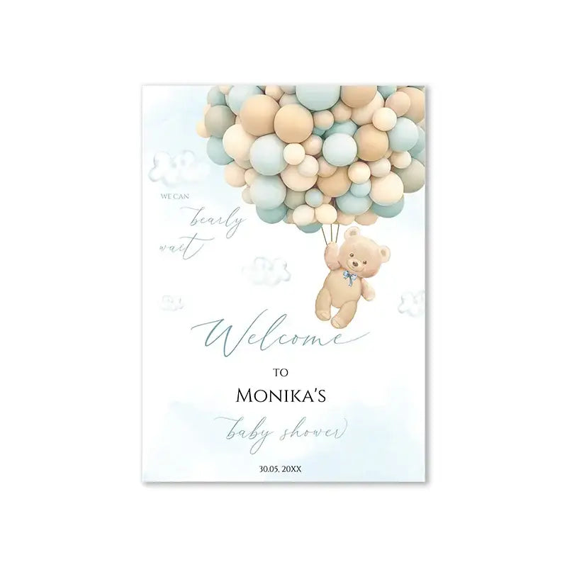A soft beige teddy bear with a blue bow tie floats among pastel balloons on a DecorBites teddy bear baby shower sign