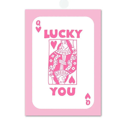 Decorbites pink angel number poster featuring a pink queen of hearts playing card with lucky you lettering