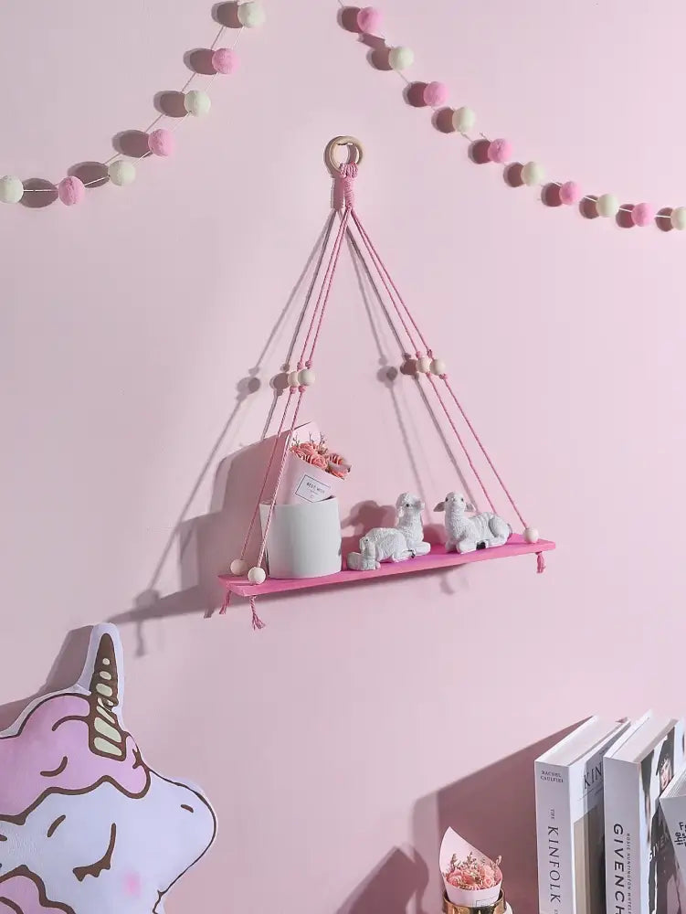 Pink green wooden macrame hanging shelf with wooden beads and woven rope frame for kids room by DecorBites