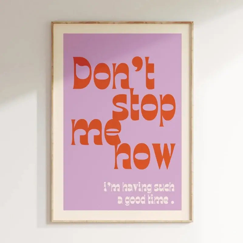 A framed DecorBites pink music lyrics wall art canvas with bold orange and white text on a lavender background