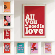 Red framed DecorBites™ pink music lyrics wall art canvas with bold white text reading all you need is love wall art canvas