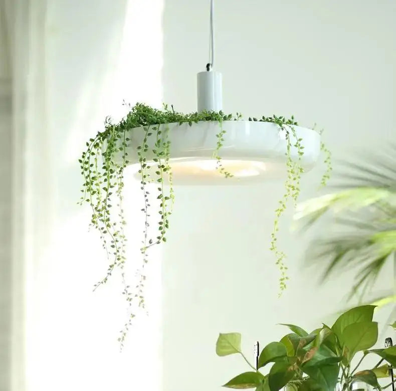 Decorbites™ white circular planter pendant lighting with cascading green vines growing from its rim