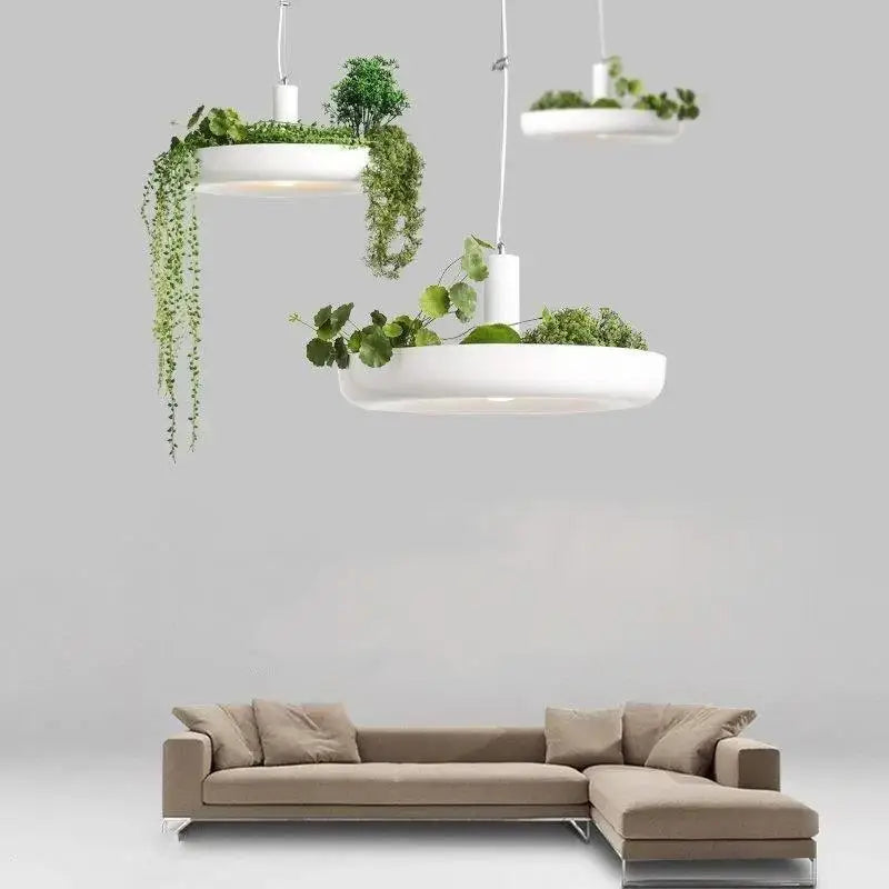 DecorBites™ white circular planter pendant lighting with integrated planters holding lush green foliage