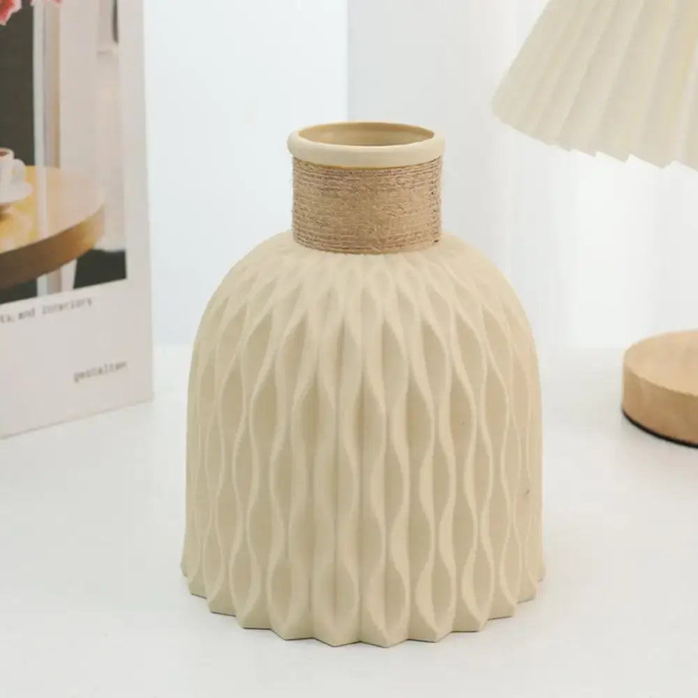 Cream-colored ceramic plastic vase with textured wavy pattern and natural twine rope neck for flower arrangement