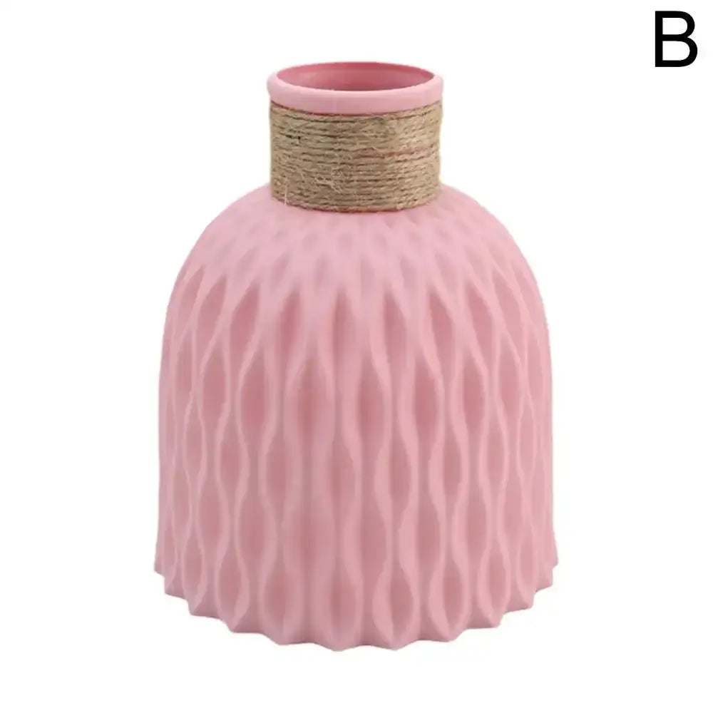 Pink ceramic plastic vase with textured wavy pattern and natural twine wrapped neck for flower arrangement