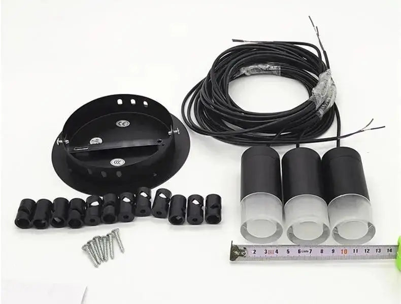 Black cylindrical decorbites™ plug-in hanging lights with frosted glass diffusers, mounting hardware, and wiring included