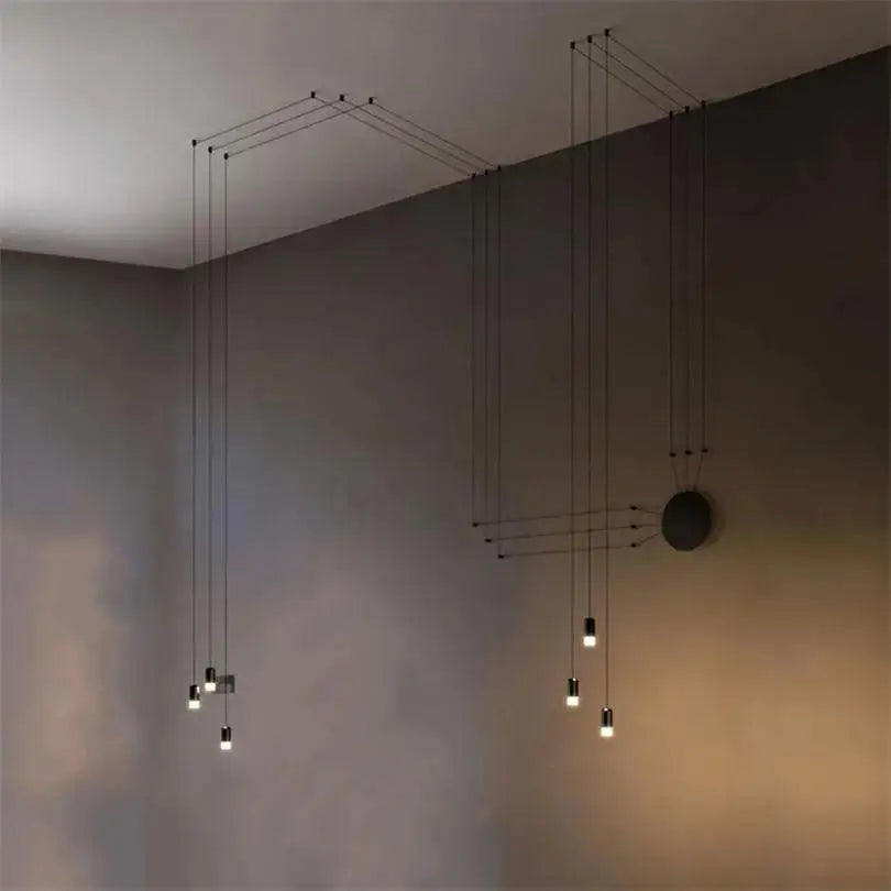 Minimalist black geometric DecorBites™ plug-in hanging lights with slender cords and small illuminated bulbs