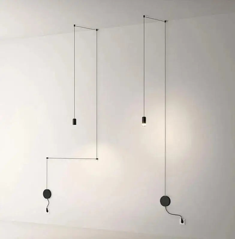 Minimalist black DecorBites™ plug-in hanging lights with slender cords and circular wall-mounted bases for modern decor