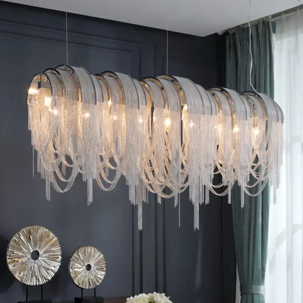 A modern aluminum tassel pendant lighting ceiling light with clear glass bead fringe and metallic frames for island use