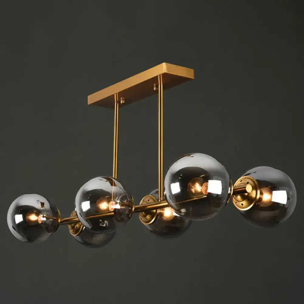 Modern brass chandelier by decorbites with five reflective smoked globe glass shades for stylish ceiling lighting