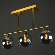 Decorbites postmodern brass island light with gold-toned metal fixture and three globe glass shades with filament bulbs