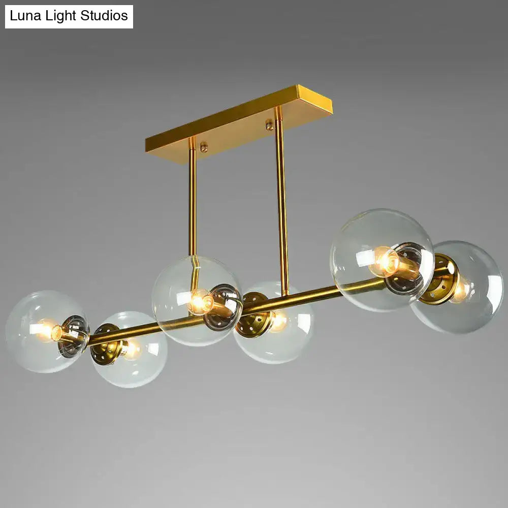 DecorBites™ postmodern brass island light with gold-toned metal and globe glass shade for stylish ceiling decor