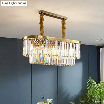 Gold-toned postmodern oblong island light with clear crystal rod tiers and ornate hanging chains for dining room use