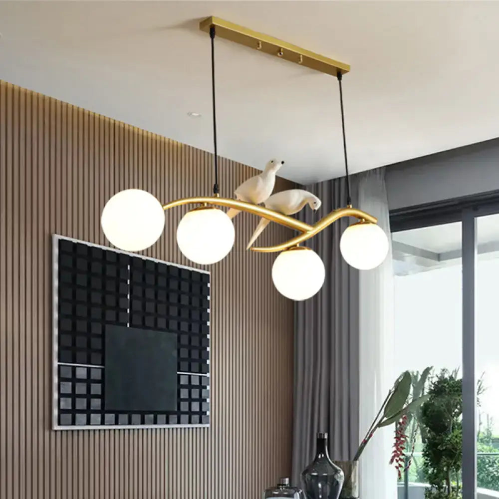 Gold-toned decorbites postmodern island lamp tree chandelier with four glass bulbs and decorative bird lamp tree branch design